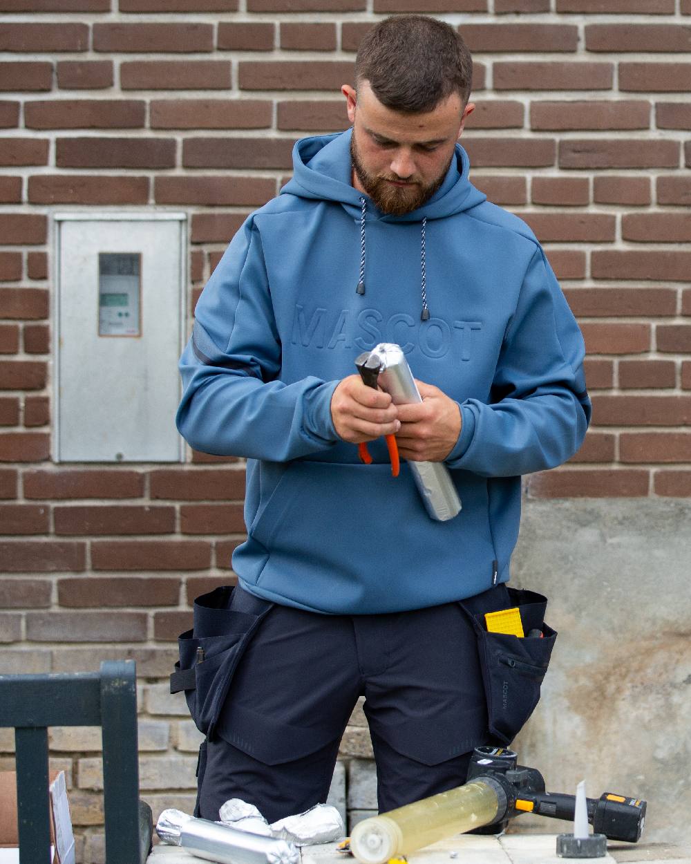 Dark Navy Coloured Mascot Workwear Customized Craftsman Holster Pockets on construction background 