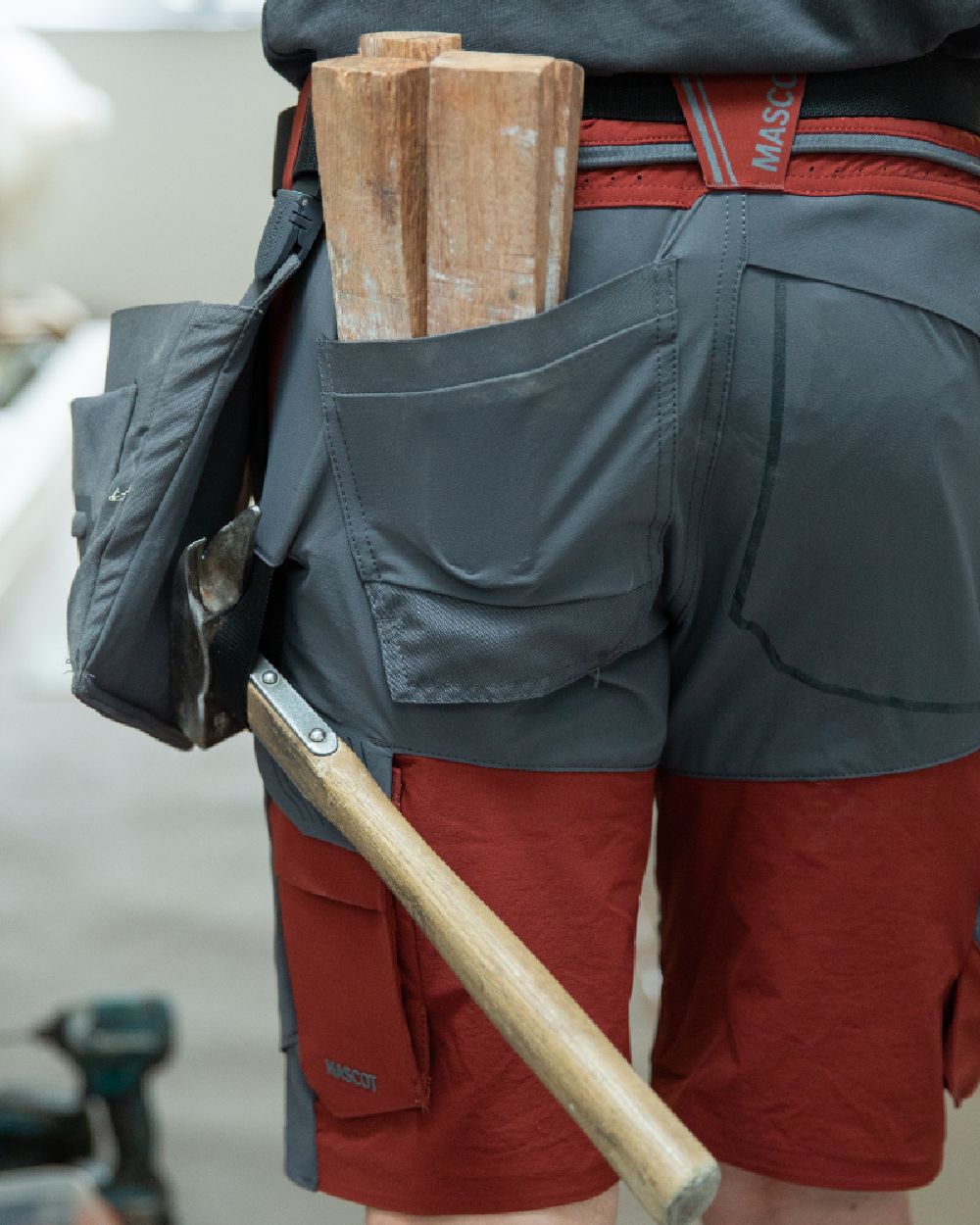 Forest Green Coloured Mascot Workwear Customized Craftsman Holster Pockets on construction background 