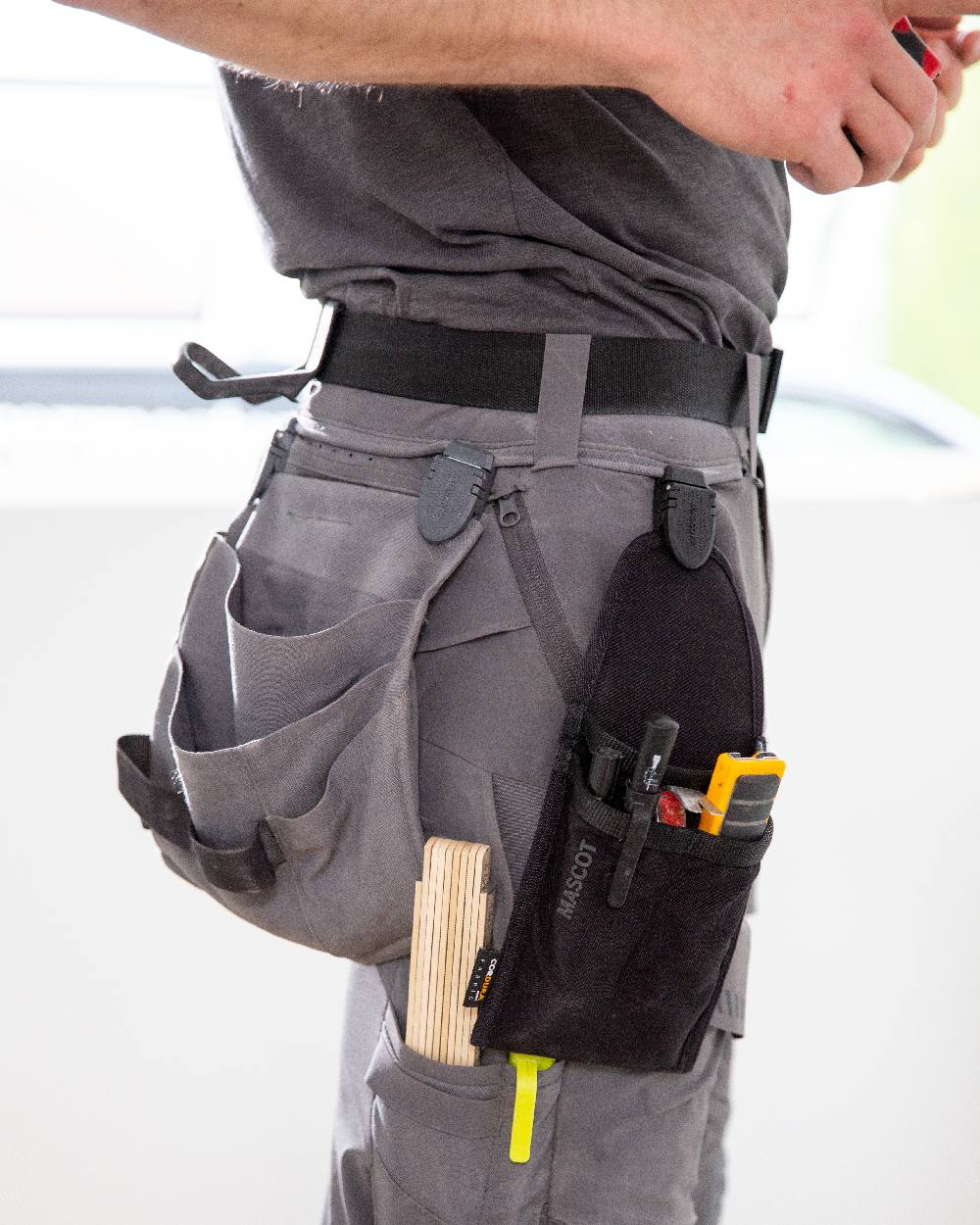 Stone Grey Coloured Mascot Workwear Customized Craftsman Holster Pockets on construction background 