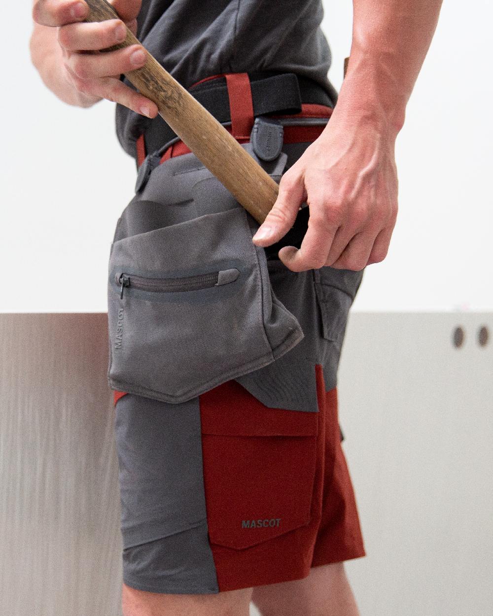 Stone Grey Coloured Mascot Workwear Customized Craftsman Holster Pockets on construction background 