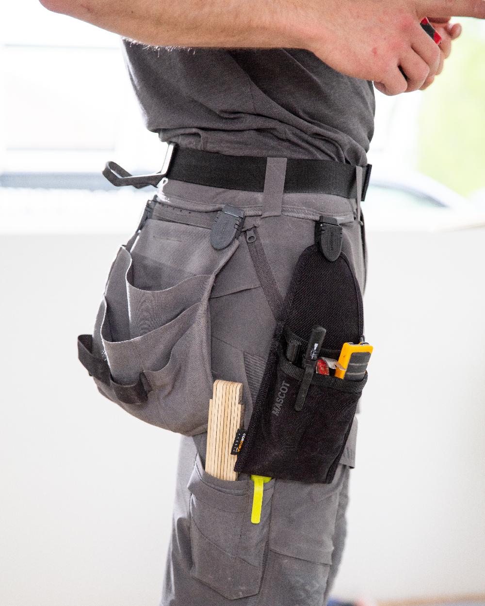 Black Coloured Mascot Workwear Customized Holster Pocket on outdoor background 