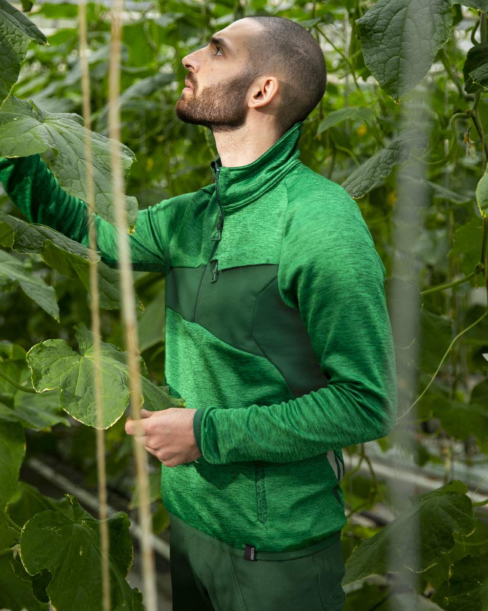 Grass Green Coloured Mascot Workwear Mens Accelerate Fleece Jumper With Half Zip on farm background 