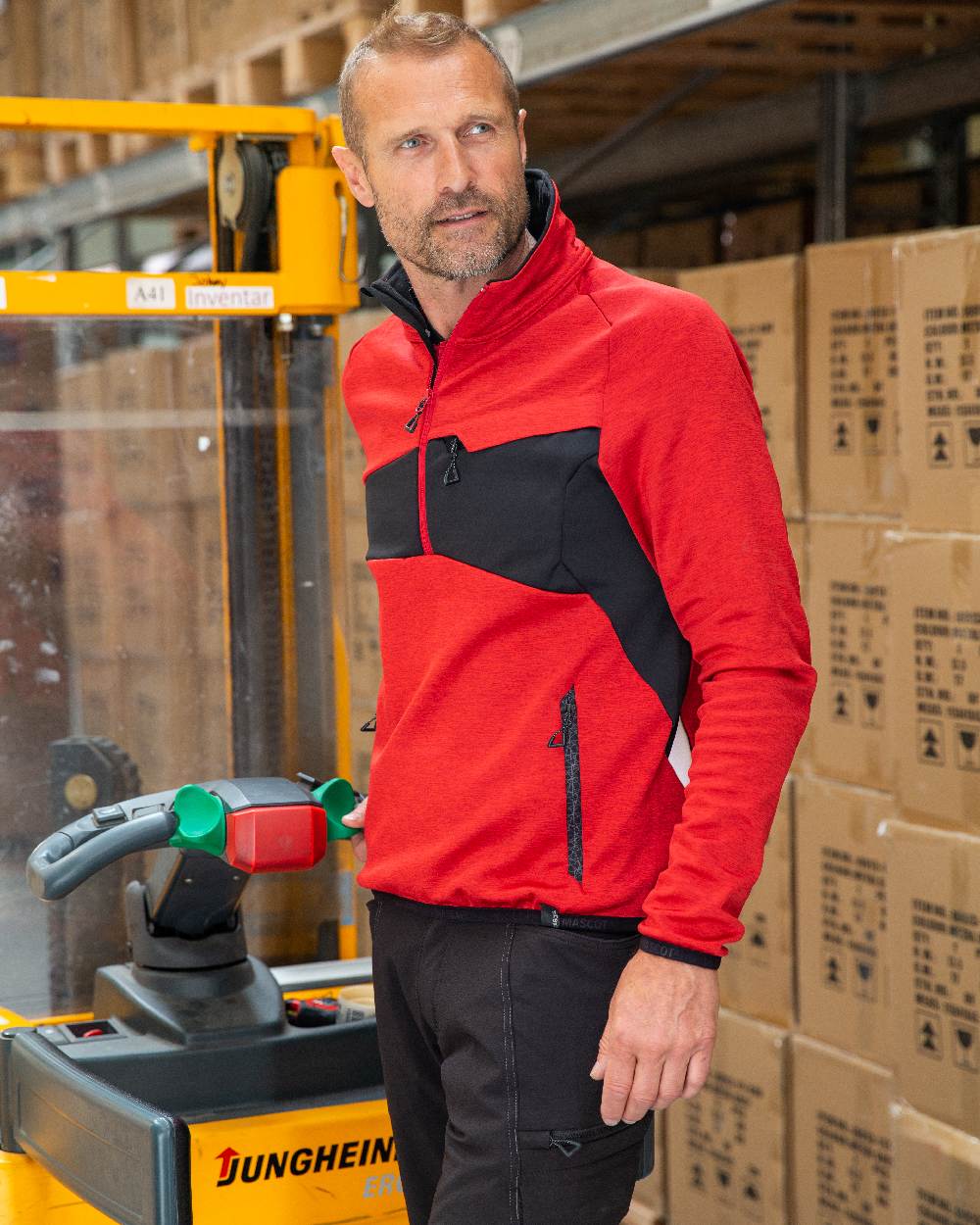 Traffic Red Black Coloured Mascot Workwear Mens Accelerate Fleece Jumper With Half Zip on farm background 