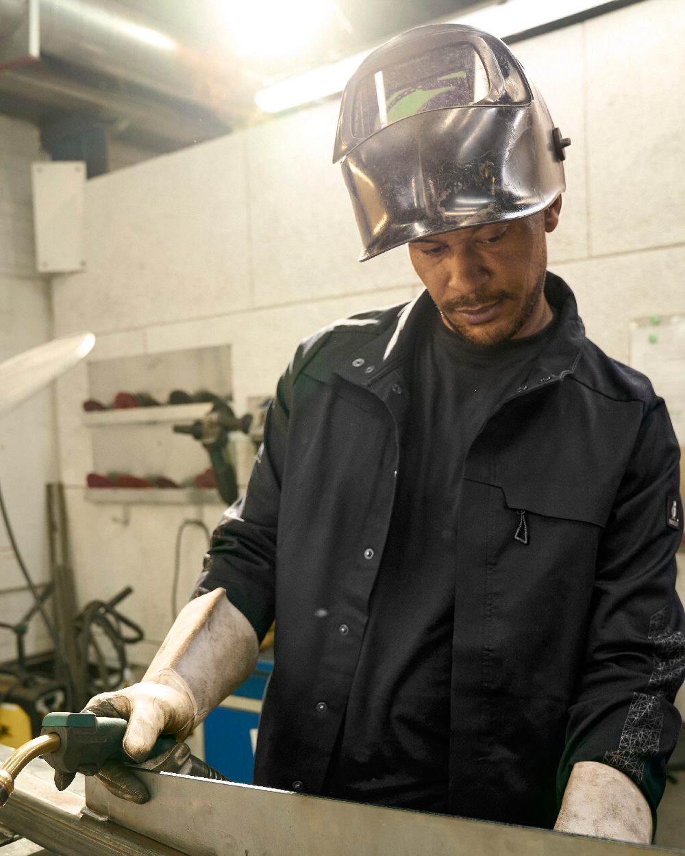 Black Mascot Workwear Mens Accelerate Jacket on factory background 