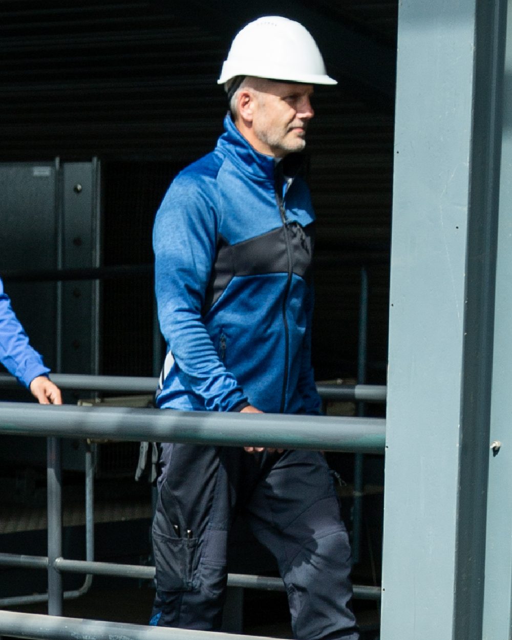 Azure Blue Dark Navy Coloured Mascot Workwear Mens Accelerate Lightweight Jacket on factory background 