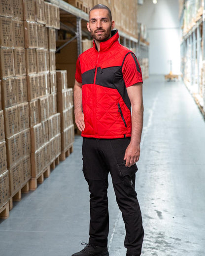 Traffic Red Black Coloured Mascot Workwear Mens Accelerate Lightweight Thermal Gilet on warehouse background 