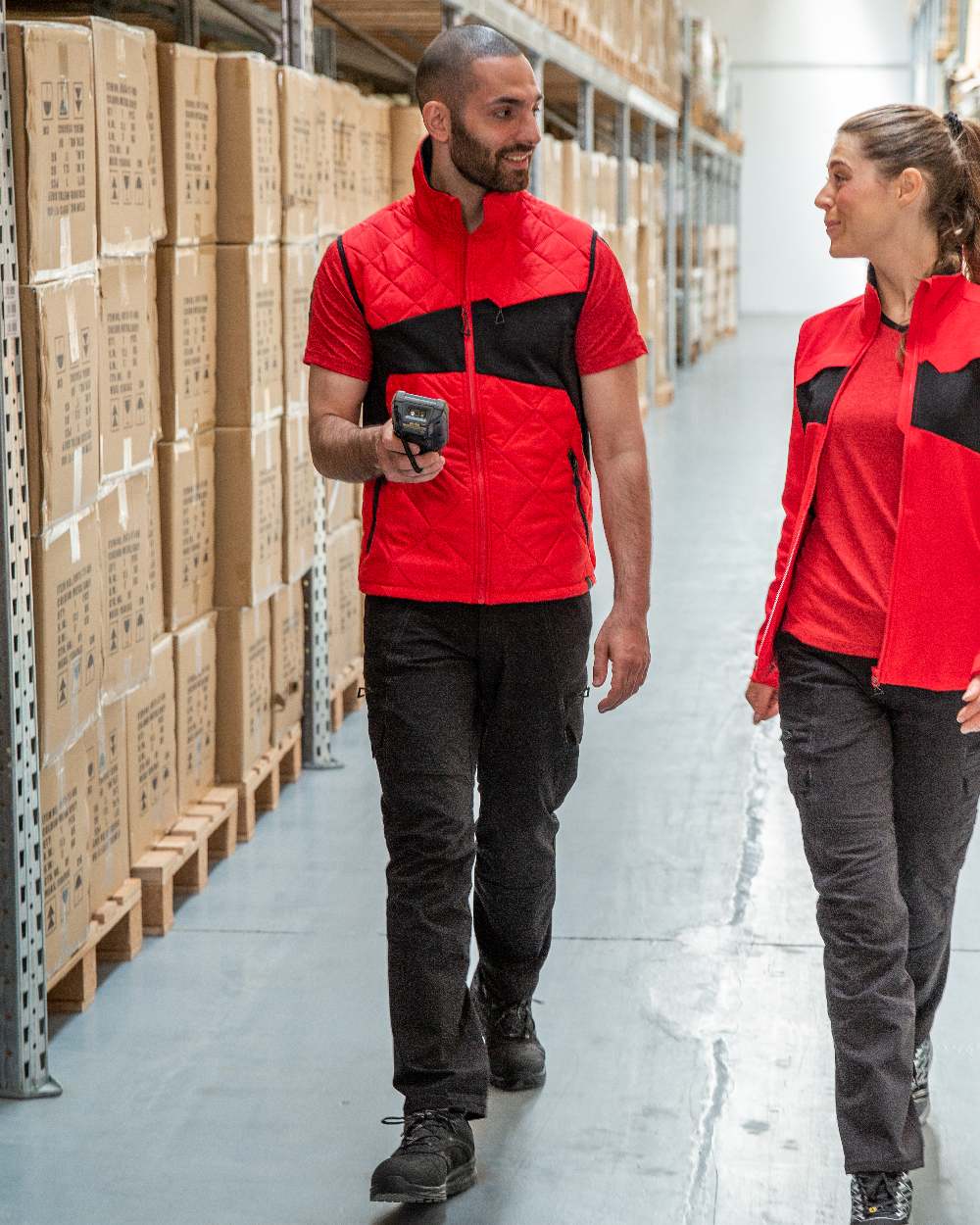 Traffic Red Black Coloured Mascot Workwear Mens Accelerate Lightweight Thermal Gilet on warehouse background 
