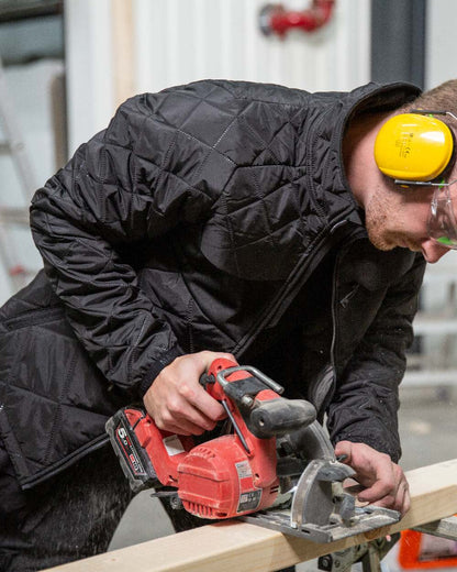 Black Coloured Mascot Workwear Mens Accelerate Lightweight Thermal Jacket on construction background 