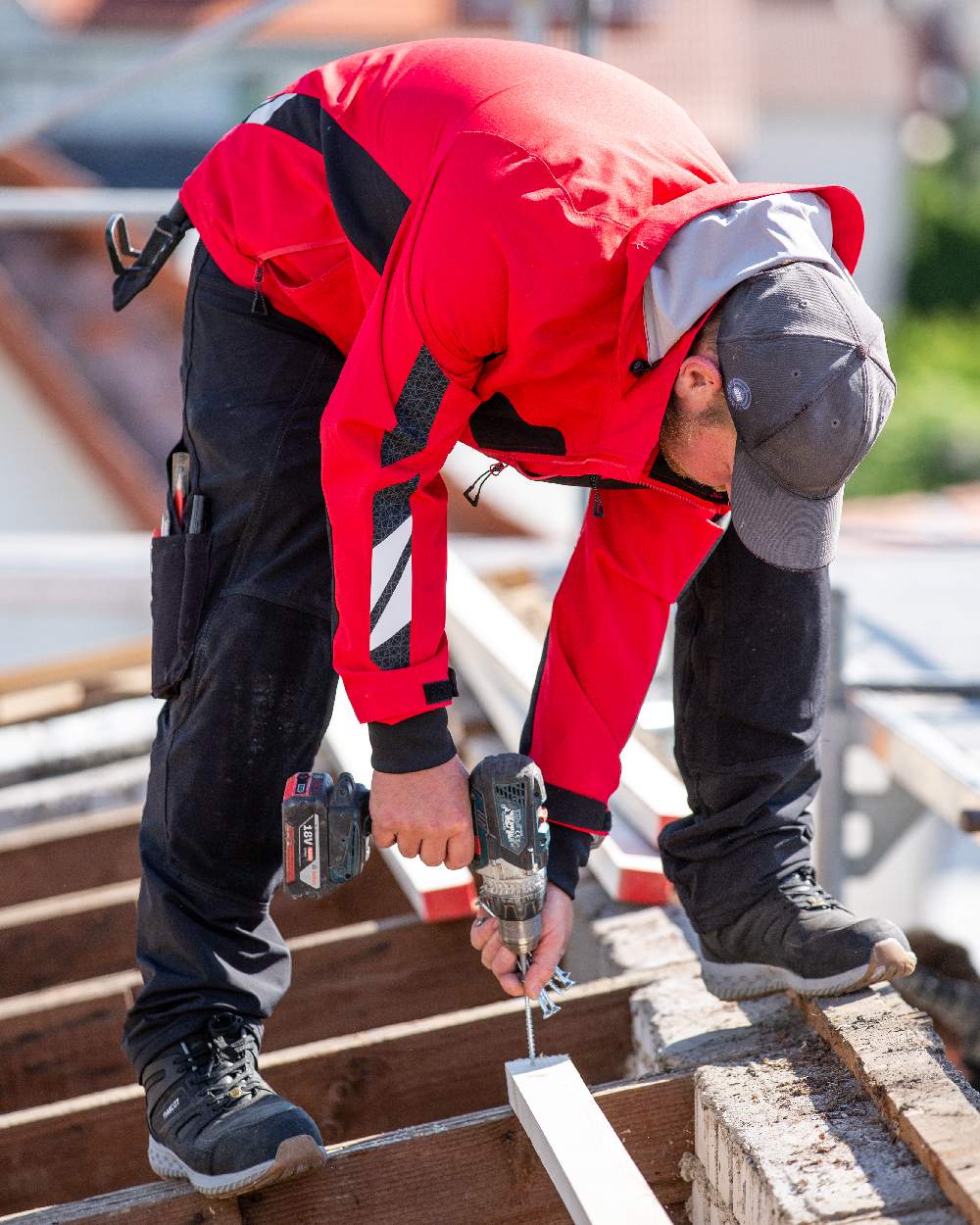 Traffic Red Black Coloured Mascot Workwear Mens Accelerate Outer Shell Jacket on construction background 