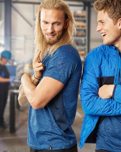 Azure Blue Dark Navy Coloured Mascot Workwear Mens Accelerate Polo Shirt on factory background 