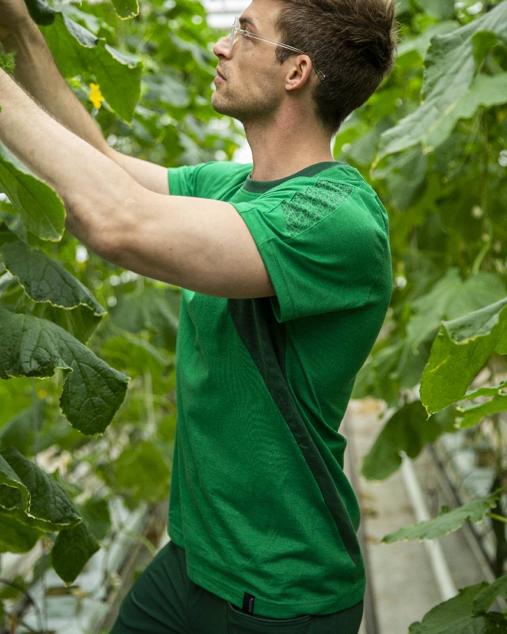 Grass Green Colored Mascot Workwear Mens Accelerate Short Sleeve T-Shirt on farm background 
