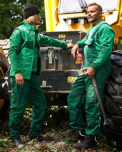 Green Coloured Mascot Workwear Mens Accelerate Stretch Zones Bib &amp; Brace With Kneepad Pockets on outdoor background 