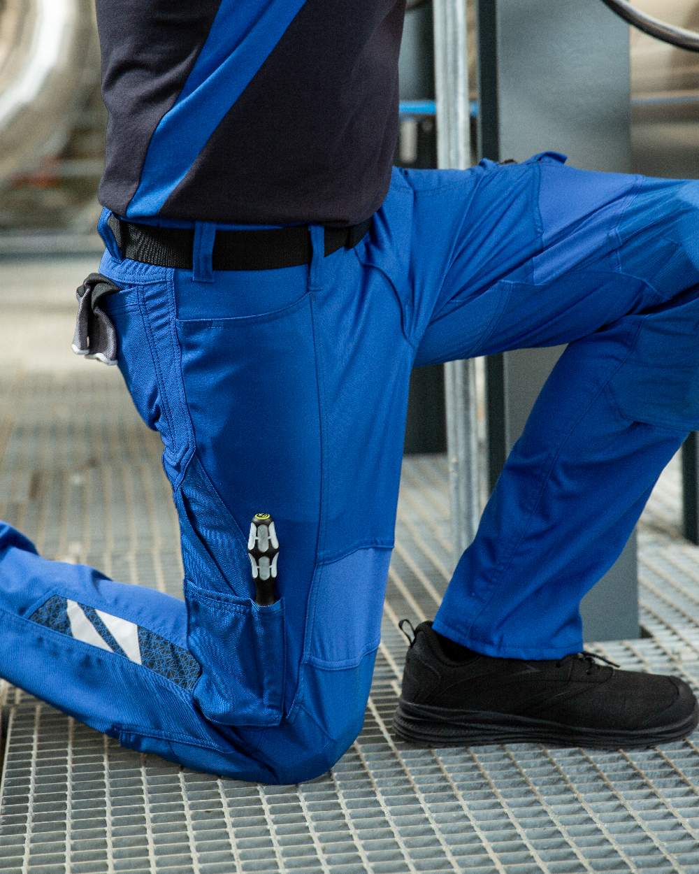 Azure Blue Coloured Mascot Workwear Mens Accelerate Stretch Zones Trousers on construction background 
