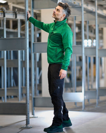 Black Coloured Mascot Workwear Mens Accelerate Stretch Zones Trousers on construction background 