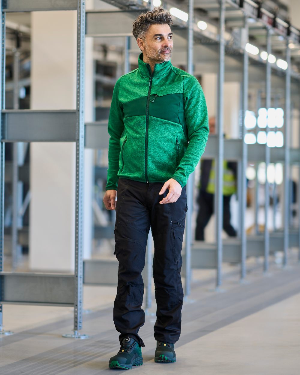 Black Coloured Mascot Workwear Mens Accelerate Stretch Zones Trousers on construction background 