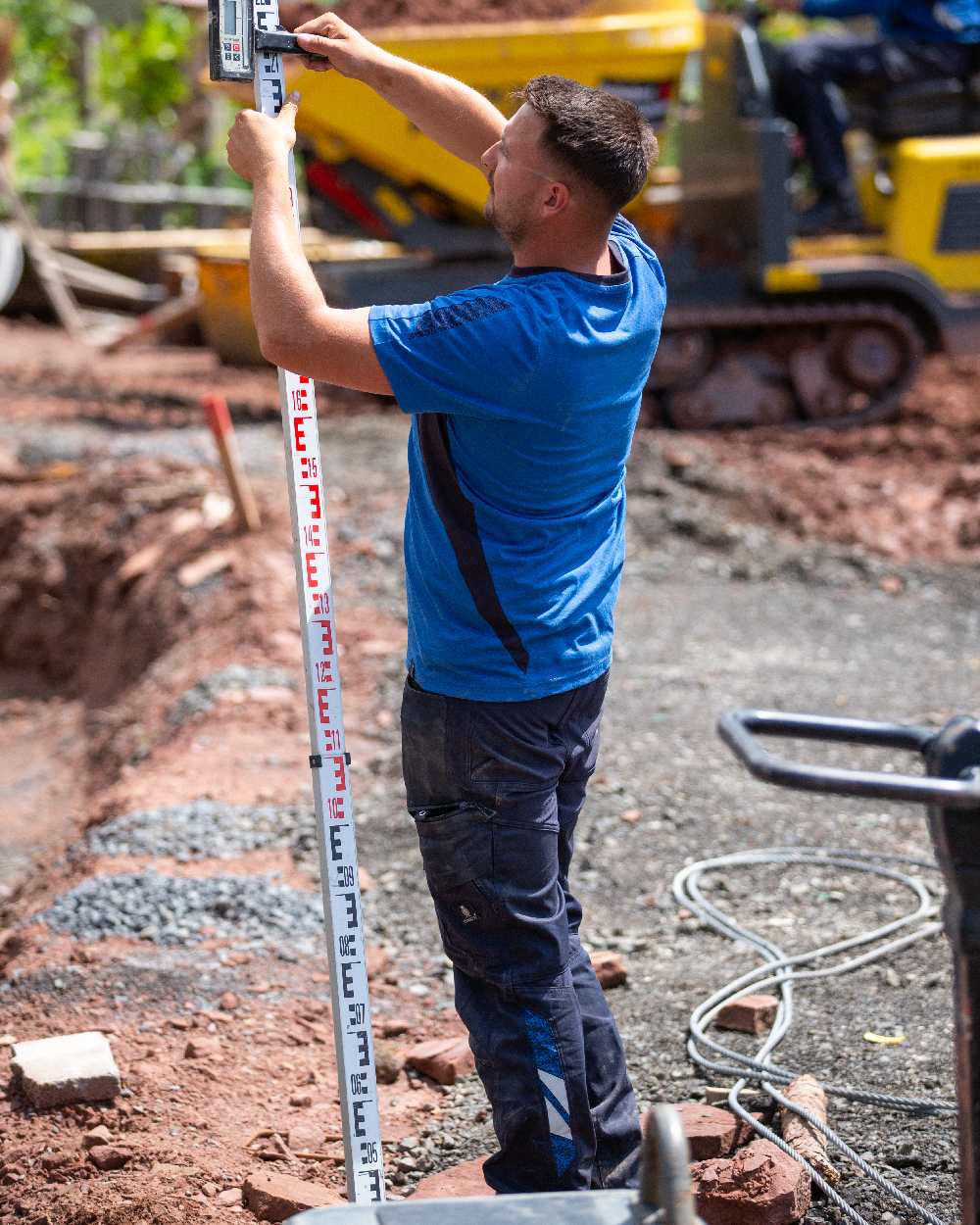 Dark Navy Coloured Mascot Workwear Mens Accelerate Stretch Zones Trousers on outdoor background 
