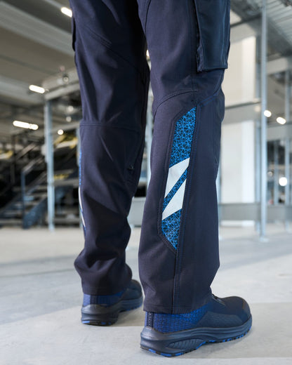 Dark Navy Coloured Mascot Workwear Mens Accelerate Ultimate Stretch Lightweight Trousers on factory background 