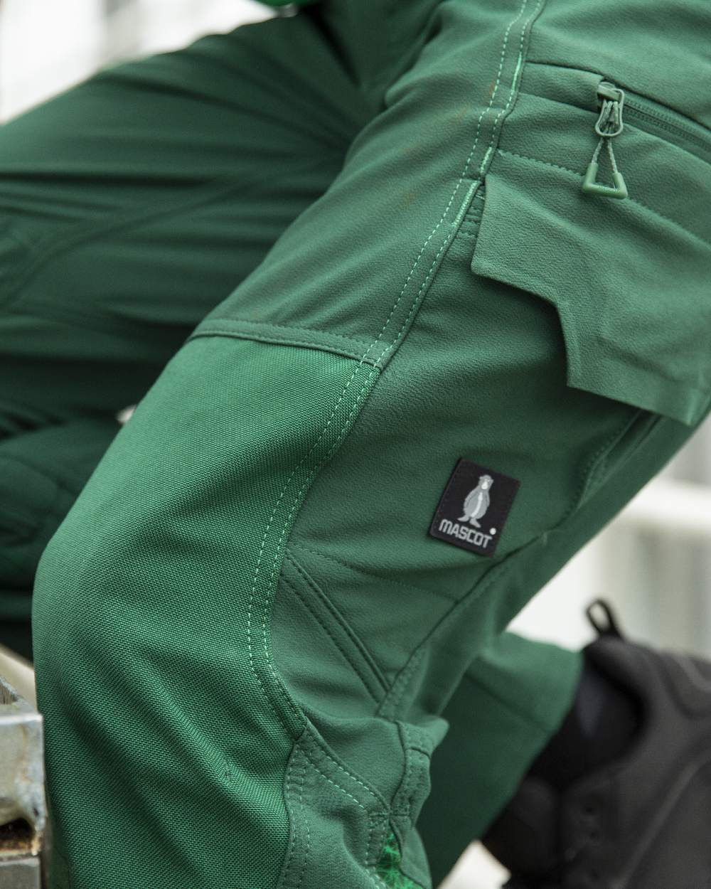 Green Coloured Mascot Workwear Mens Accelerate Ultimate Stretch Lightweight Trousers on farm background 