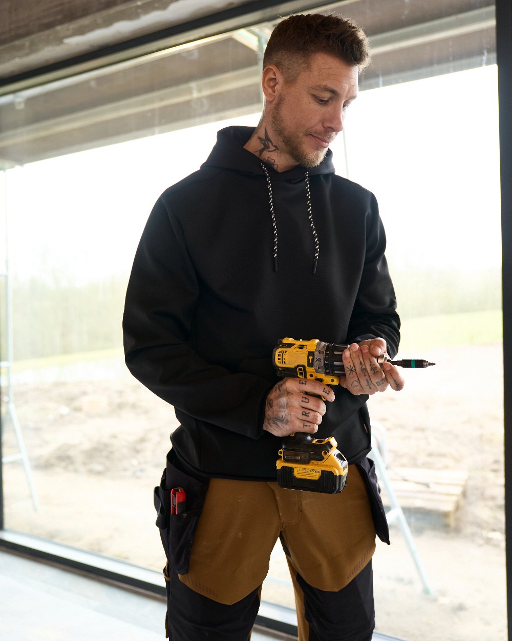 Black Coloured Mascot Workwear Mens Customized Fleece Hoodie on construction background 