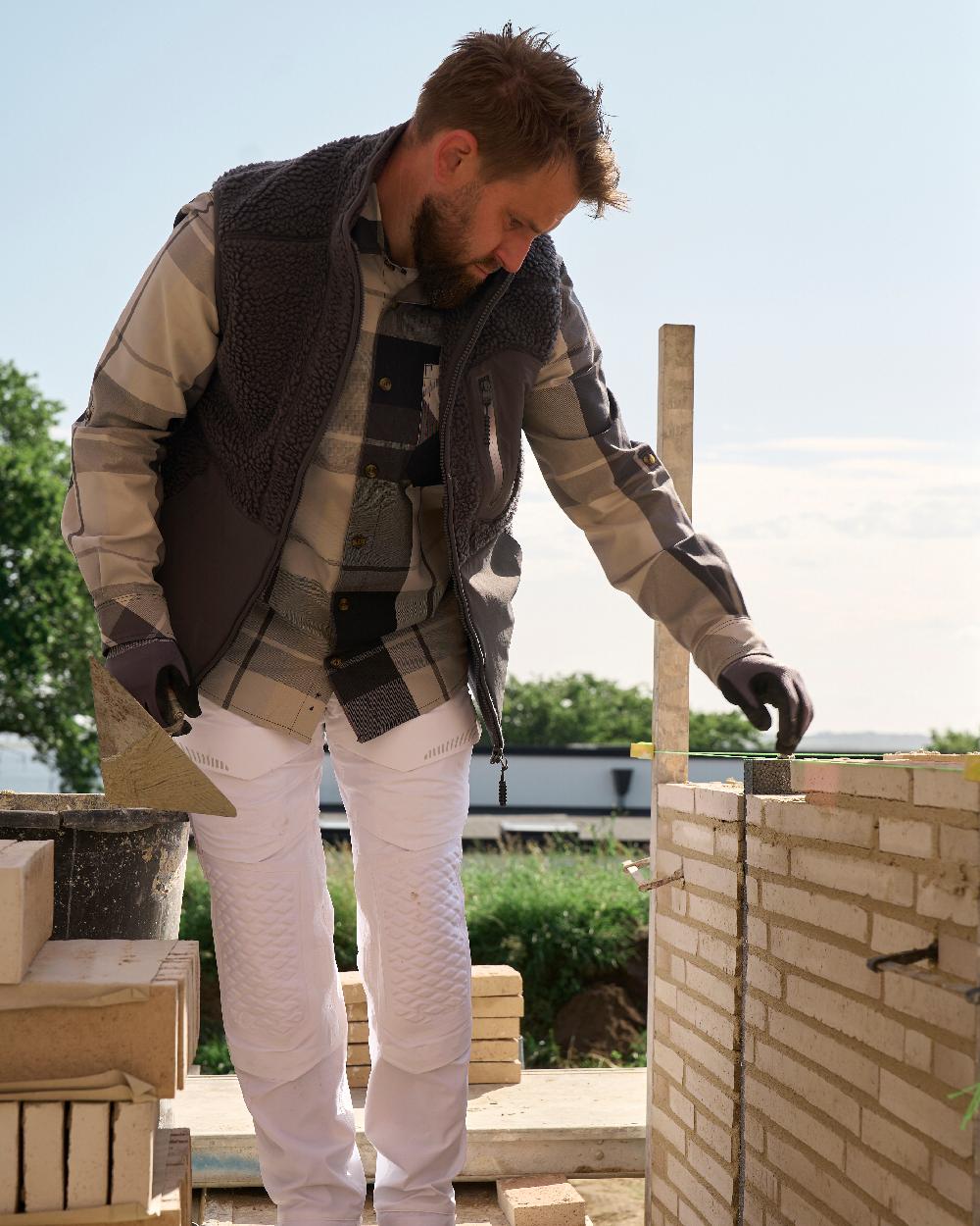 Stone Grey Coloured Mascot Workwear Mens Customized Pile Gilet With Zipper on construction background 