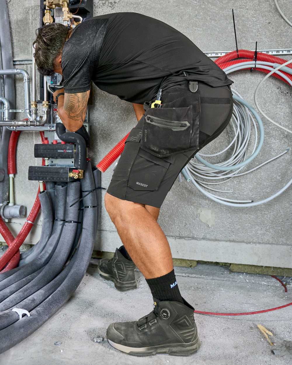 Black Coloured Mascot Workwear Mens Customized Short Sleeve T-Shirt on construction background 