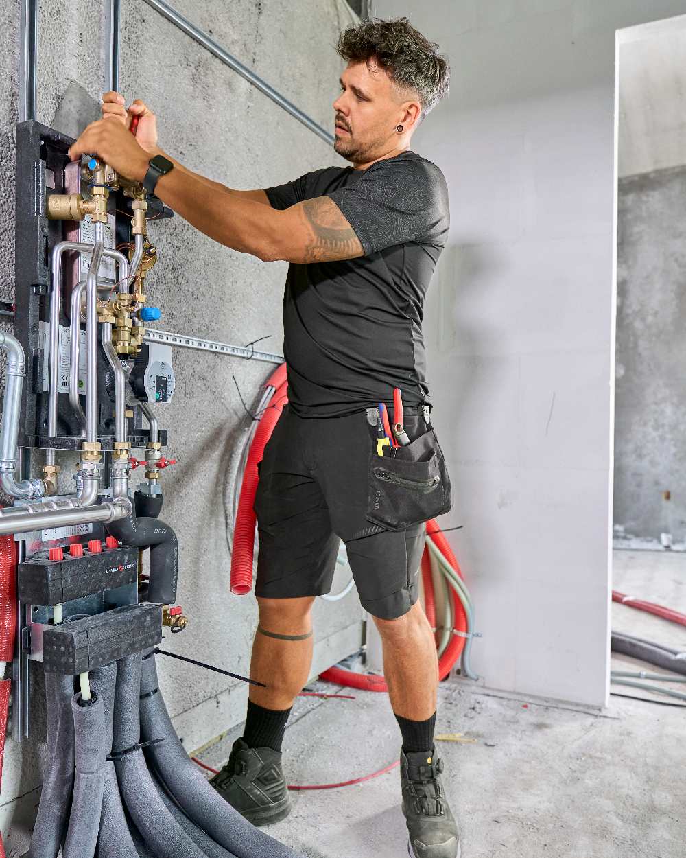 Black Coloured Mascot Workwear Mens Customized Short Sleeve T-Shirt on construction background 