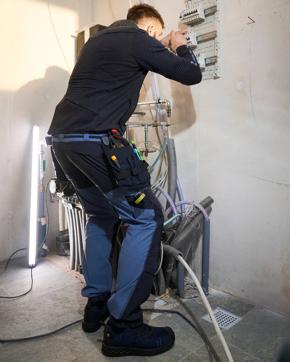 Stone Blue Dark Navy Coloured Mascot Workwear Mens Customized Ultimate Stretch Trousers on construction background 