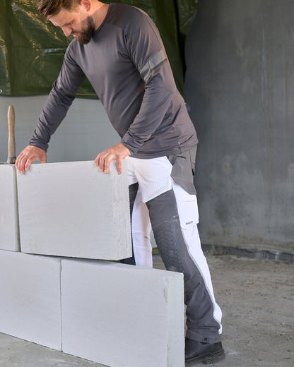 White Stone Grey Coloured Mascot Workwear Mens Customized Ultimate Stretch Trousers on construction background 