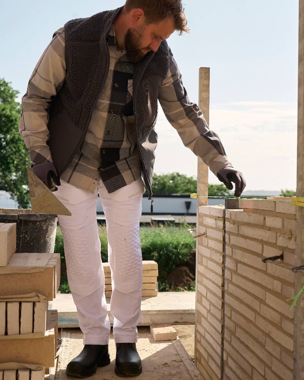 White Coloured Mascot Workwear Mens Customized Ultimate Stretch Trousers on construction background 