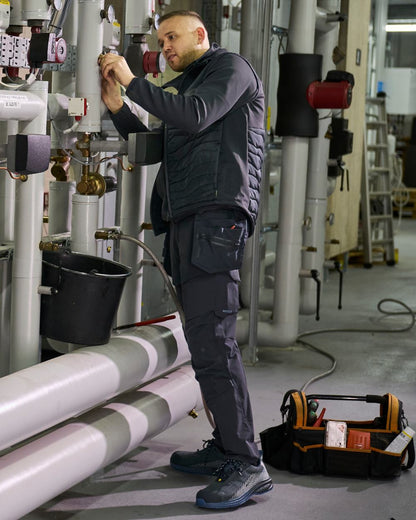 Dark Navy Coloured Mascot Workwear Mens Customized Ultimate Stretch Trousers With Kneepad Pockets on construction background 