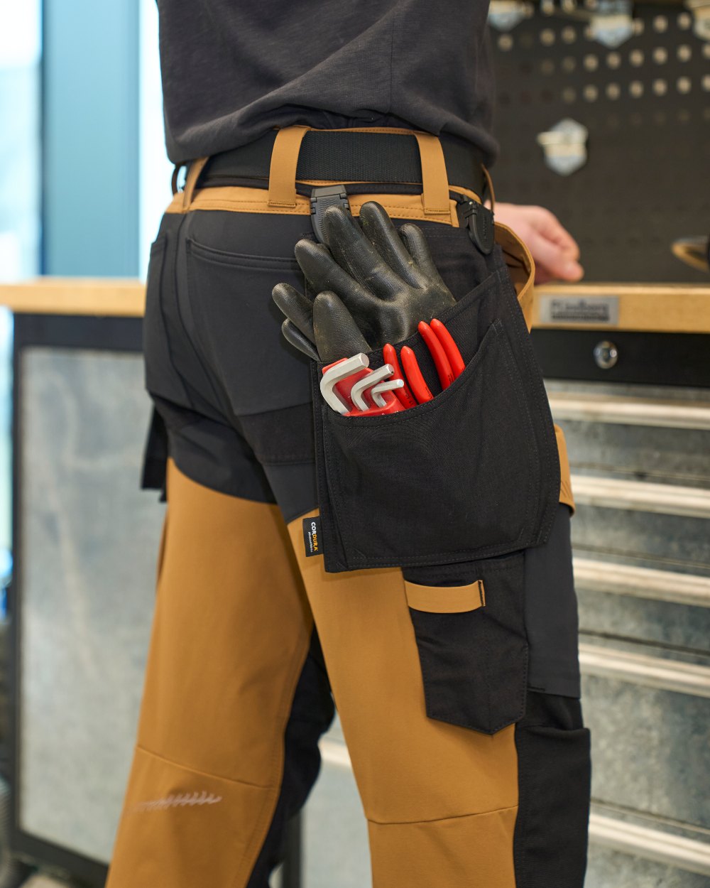 Nut Brown Black Coloured Mascot Workwear Mens Customized Ultimate Stretch Trousers With Kneepad Pockets on outdoor background 