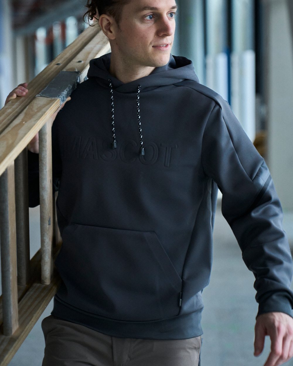Black Coloured Mascot Workwear Mens Customized Water Repellent Fleece Hoodie on construction background 
