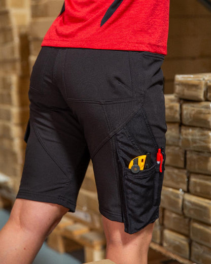 Black Coloured Mascot Workwear Womens Accelerate Diamond Fit Shorts on warehouse background 