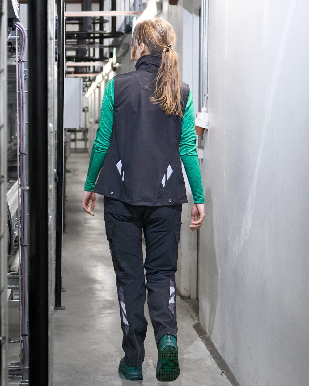 Black Coloured Mascot Workwear Womens Accelerate Gilet on factory background 