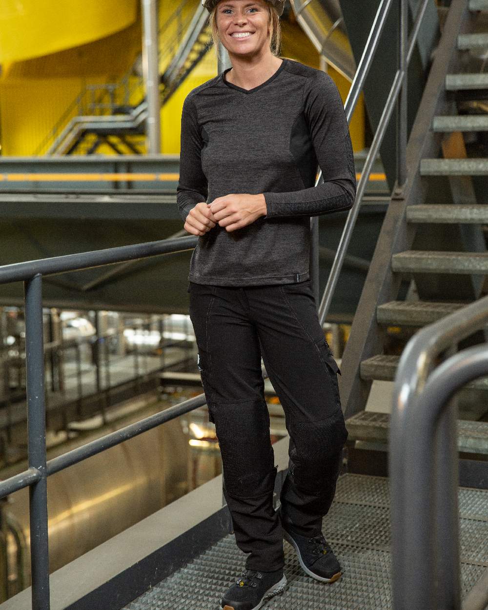 Black Coloured Mascot Workwear Womens Accelerate Lightweight Trousers With Kneepad Pockets on factory background 