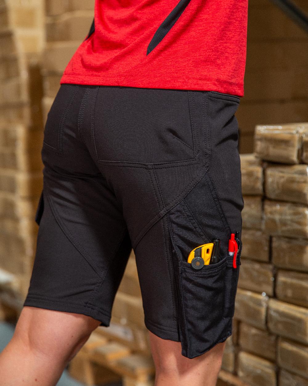 Black Coloured Mascot Workwear Womens Accelerate Pearl Fit Shorts on warehouse background 