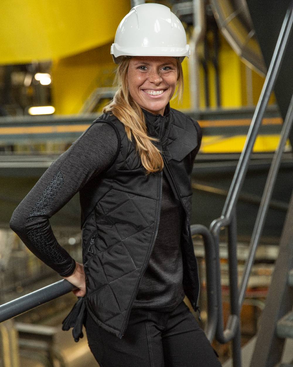 Black Coloured Mascot Workwear Womens Accelerate Thermal Gilet on factory background 