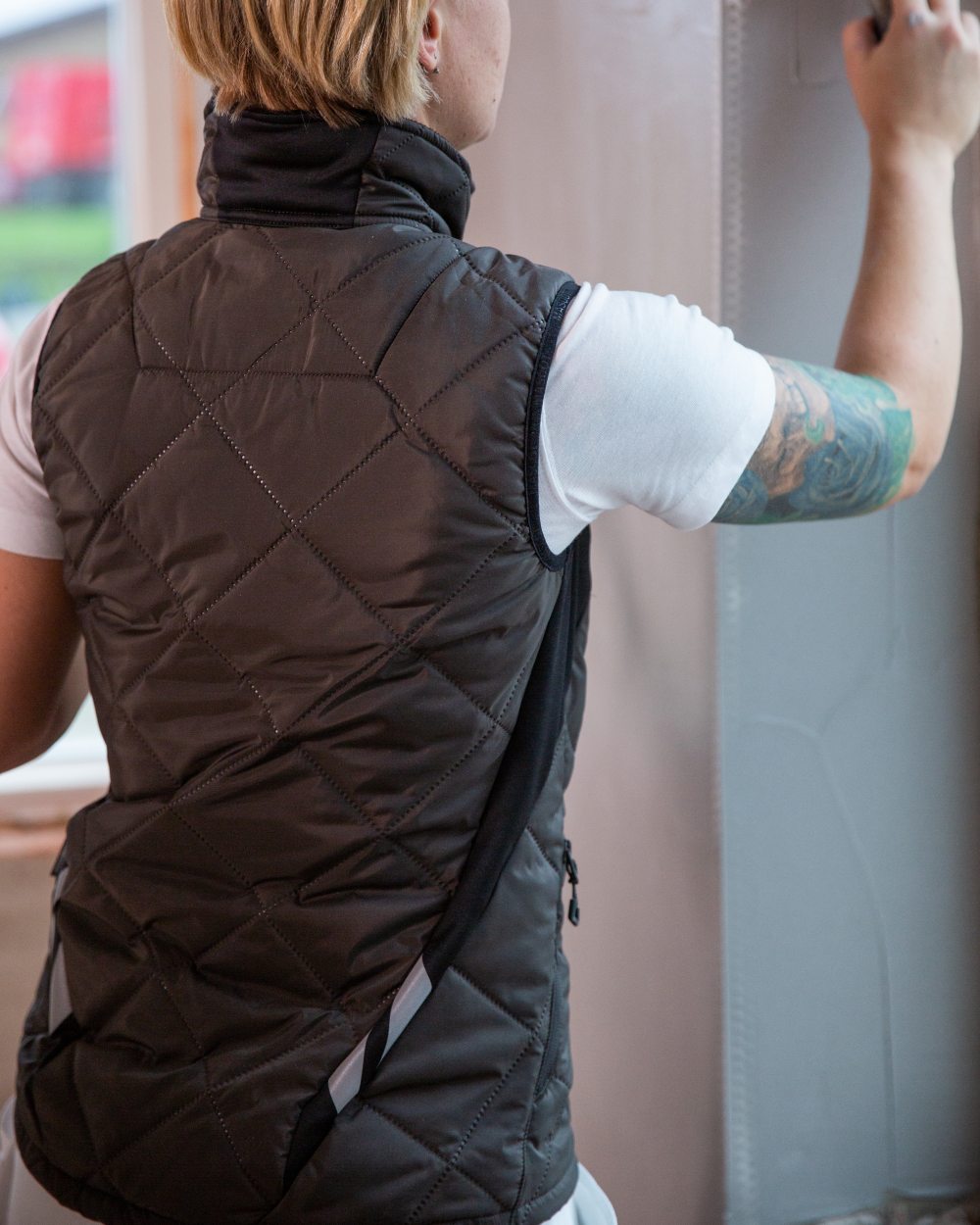 Dark Anthracite Black Coloured Mascot Workwear Womens Accelerate Thermal Gilet on indoor background 