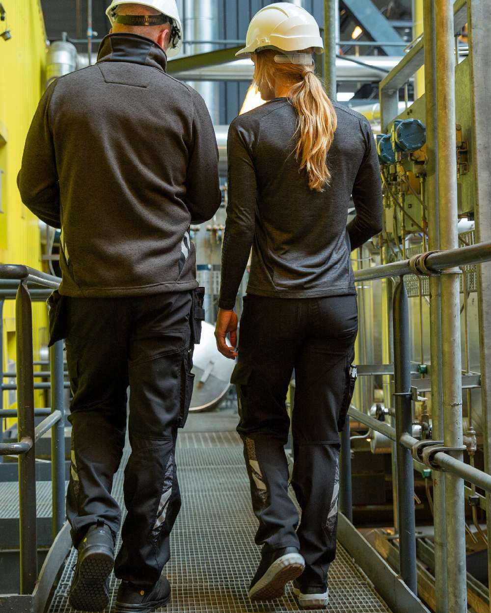 Black Coloured Mascot Workwear Womens Accelerate Trousers With Kneepad Pockets on factory background 