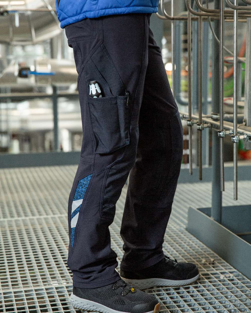 Dark Navy Coloured Mascot Workwear Womens Accelerate Trousers With Kneepad Pockets on factory background 