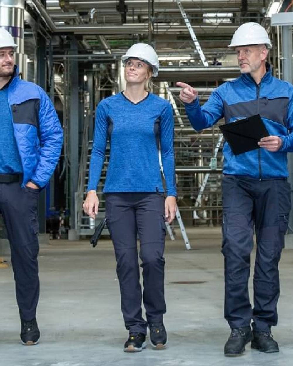 Dark Navy Coloured Mascot Workwear Womens Accelerate Trousers With Thigh Pockets on factory background 