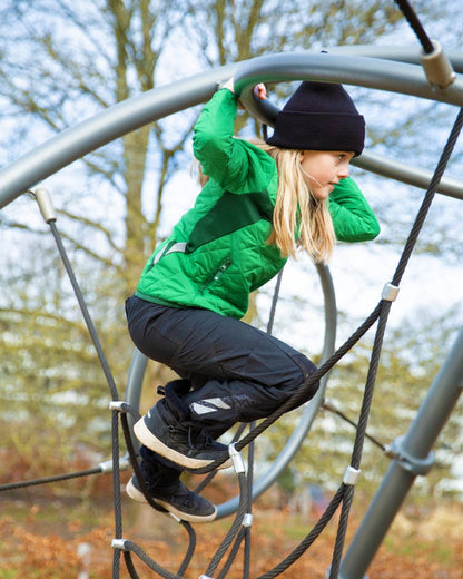 Black coloured Mascot Workwear Childrens Accelerate Pants on park background 