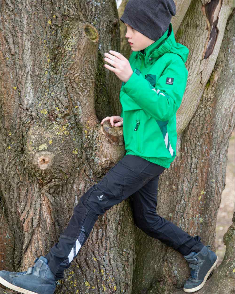 Black coloured Mascot Workwear Childrens Accelerate Pants on tree background 