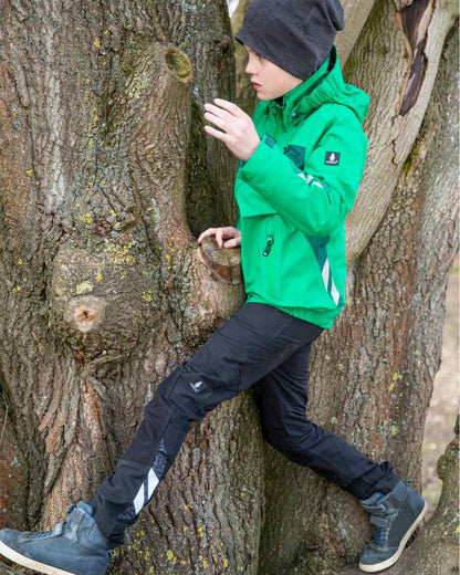 Black coloured Mascot Workwear Childrens Accelerate Pants on tree background 