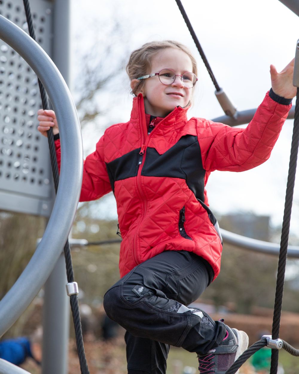 Traffic Red Black coloured Mascot Workwear Childrens Accelerate Water Repellent Jacket on park background 