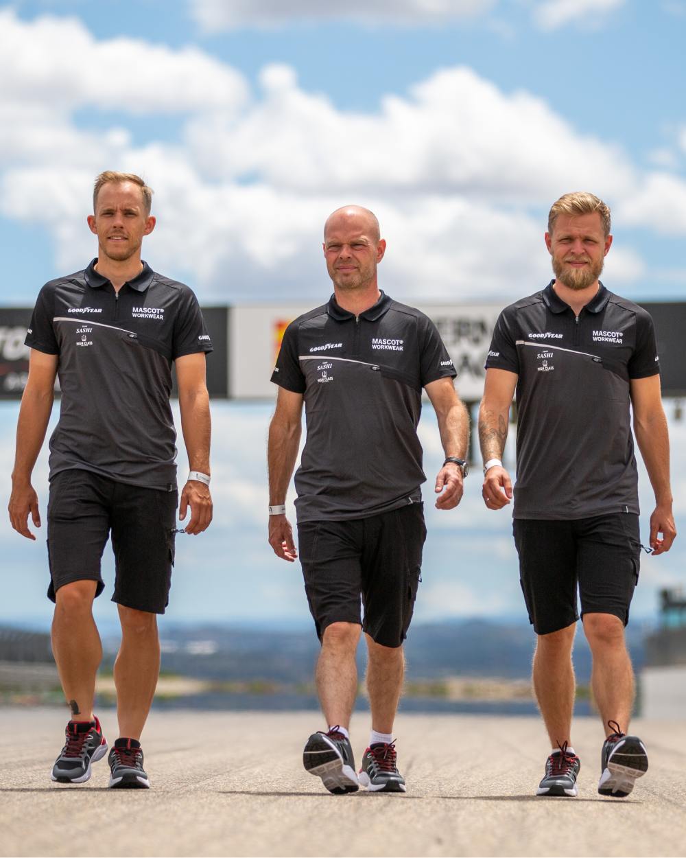 Black coloured Mascot Workwear Mens Accelerate Shorts on race course background 