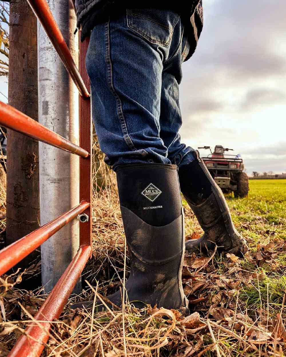 Black Coloured Muck Boots Muckmaster Tall Boot on farm background 
