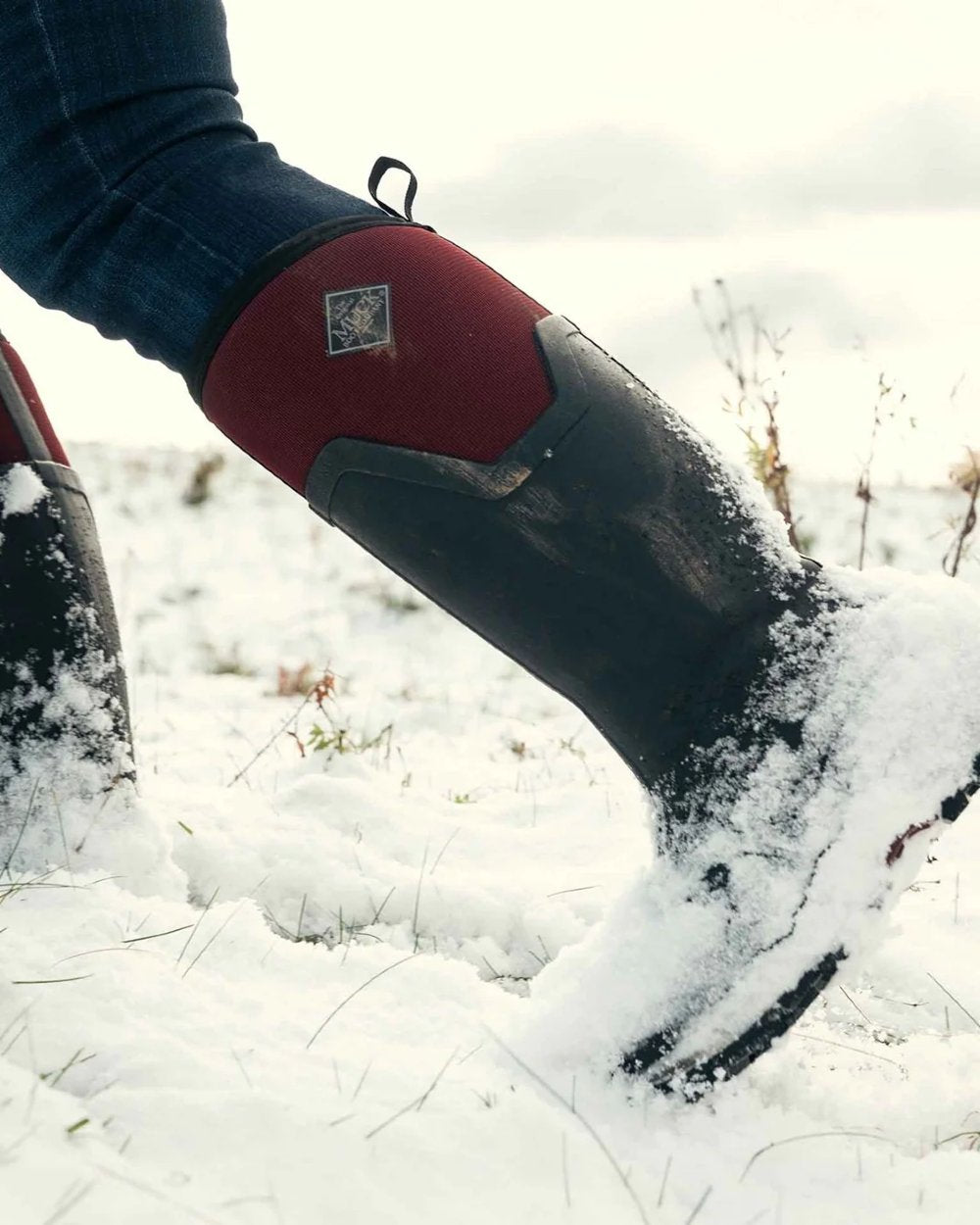 Black Windsor Wine coloured Muck Boots Womens Arctic Ice Tall Wellingtons on snow background 