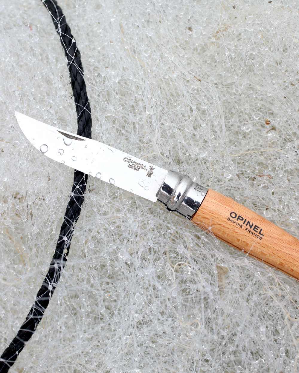 Stainless Steel coloured Opinel Classic Originals Non-Locking Knife on net background 