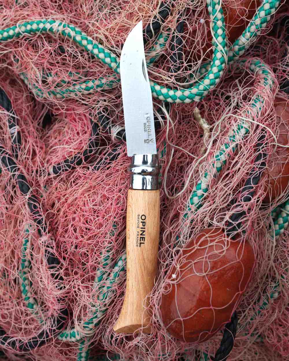 Stainless Steel coloured Opinel Classic Originals Non-Locking Knife on net background 